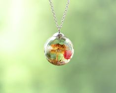 Capture the essence of the forest with this beautiful dried mushroom necklace, featuring real dried mushrooms 🍄 and flowers 🌸, preserved in a clear resin terrarium pendant. This miniature necklace is perfect for those who love unique, nature-inspired jewelry and want to carry a little piece of the outdoors with them wherever they go. This delicate terrarium resin necklace makes a thoughtful and unique nature-inspired gift for her 🎁. Whether for a birthday, anniversary, or just because, this mushroom jewelry brings the magic of the forest into a wearable treasure. 🌻 Our Mushroom Jewelry: https://www.etsy.com/shop/NatureResinJewelry?section_id=51201375 💚 Handmade with love and care 💚 ADDITIONAL INFORMATION 🎁 This unique nature necklace comes carefully packaged in a gift box, making it Resin Terrarium, Real Flower Necklace, Mushroom Necklace, Mushroom Jewelry, Dried Mushrooms, Nature Necklace, Unique Nature, Box Making, Nature Inspired Jewelry