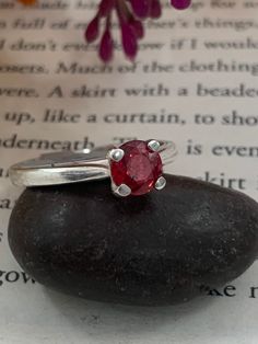 African Ruby hand set in a sterling silver mount.  Ring is size N, however it can be resized depending on your ring size. Please message for more details on resizing. Stone is 5.5 mm at its highest point  The stone is a beautiful striking red  Ring is hallmarked Sterling silver Classic Ruby Ring With Polished Round Stone, Classic Round Crystal Birthstone Ring, Hallmarked Round Sapphire Ring, Classic Ruby Solitaire Rings, Sterling Silver Oval Birthstone Promise Ring, Classic Ruby Birthstone Ring With Round Band, Ruby Birthstone Ring For Promise, Anniversary Ruby Ring With Polished Round Stone, Classic Sterling Silver Birthstone Ring