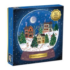 a christmas snow globe with houses and trees in the snow under a moonlit sky