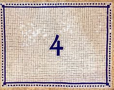 the number four is displayed on a tile wall