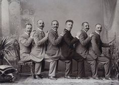 an old black and white photo with five men in suits posing for the camera, caption says okay guys, i have a great idea for a group photo