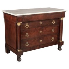 an old wooden chest with marble top and brass hardware on the bottom, against a white background