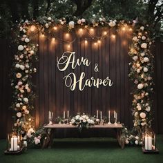 an outdoor ceremony with candles and flowers on the table, surrounded by greenery that reads ava & harper