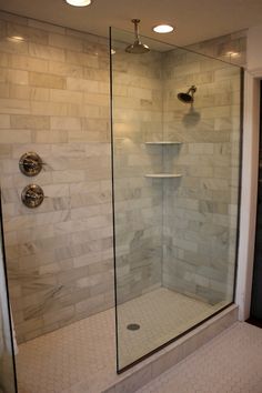 a walk in shower sitting inside of a bathroom