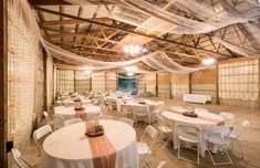 a banquet hall with white tables and chairs