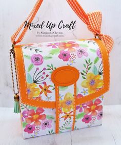 an orange and white flowered purse on a table with the words mixed up craft above it