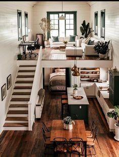 an open floor plan with stairs leading up to the loft