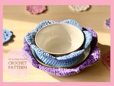 three crocheted dishes sitting on top of each other in front of a wooden table