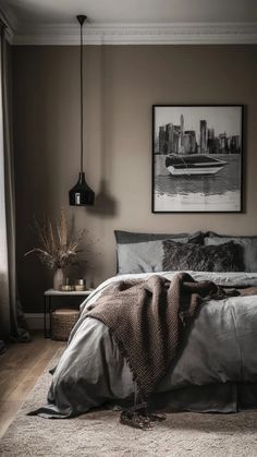 a bedroom with a large bed and two pictures on the wall above it in black and white