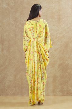 Yellow georgette kaftan with floral print and sequins and beaded hand embroidered placement patchwork. Comes with an inner.
Components: 2
Pattern: Printed, Hand embroidered
Type Of Work: Floral, Sequins, Beads
Neckline: V Neck
Sleeve Type: Kaftan : Flared Sleeves, Inner : Sleeveless
Fabric: Georgette
Color: Yellow
Other Details: 
Front pleats
Occasion: Sangeet - Aza Fashions Floor-length Georgette Kaftan For Spring, Georgette Dresses With Traditional Drape And Printed Motifs, Spring Georgette Dress With Traditional Drape, Festive Floor-length Floral Print Kaftan, Yellow Printed Georgette Dresses, Yellow Georgette Dress With Printed Motifs, Spring Kaftan With Dupatta In Traditional Drape, Traditional Drape Kaftan With Dupatta For Spring, Navratri Georgette Dress With Floral Print