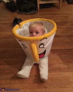 a little boy that is sitting in a bag