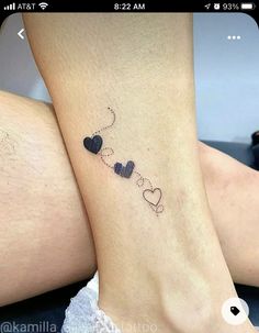 two people with matching tattoos on their legs, one has a heart and the other has a