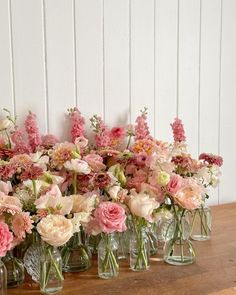 a group of vases filled with pink and white flowers