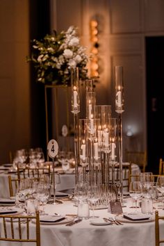 the table is set up with candles and place settings for guests to sit down at