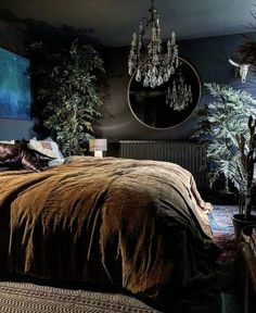 a bedroom with a large bed and chandelier hanging from the ceiling above it