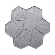 a white hexagonal tile with several pieces of cement on the top and bottom