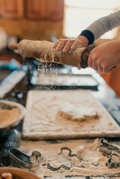 a person is kneading dough on top of a table