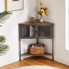 a corner shelf with flowers and pictures on it