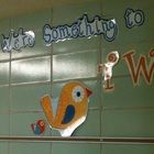 there is a sign that says something to do with birds on the wall in front of it