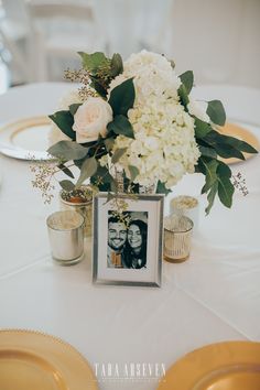 a vase filled with white flowers sitting on top of a table