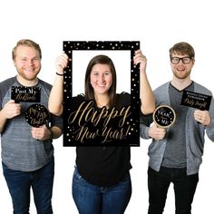 three people holding up signs that say happy new year and the numbers are in front of them