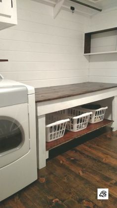 a washer and dryer sitting next to each other in a room with white walls