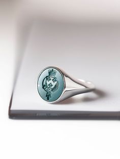 A bloodstone signet ring that can be carved with your own custom design. *real images of the ring, taken by us* Bloodstone Size: 15x13mm Material: - Sterling Silver (925) - 9K Gold (375) - 14K Gold (585) - 18K Gold (750) *All signet rings are hallmarked on the back for certification* - We offer FREE Worldwide DHL & FedEx Shipping! - Branded DanelianJewelry Gift Box with each order! Our customer service is available 7 days a week. Leave us your message, and we will get back to you within a little Oval Engraved Enamel Ring As Gift, Engraved Oval Cabochon Ring For Gift, Oval Intaglio Symbolic Rings, Oval Symbolic Intaglio Rings, Carved Sterling Silver Signet Ring For Formal Occasions, Carved Oval Signet Ring For Anniversary, Oval Carved Signet Ring For Anniversary, Formal Carved Sterling Silver Signet Ring, Hallmarked Engraved Memorial Ring