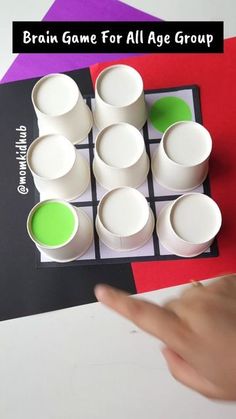 the brain game for all age groups is shown with cups and saucers on it