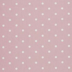 a pink and white polka dot fabric with small white dots on the back of it