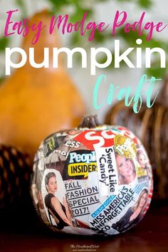 a pumpkin decorated with newspaper clippings on top of a wooden table next to other fall decorations