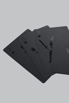 four playing cards are shown in black on a gray background, with one card missing the middle