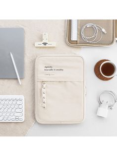 an apple laptop, keyboard, mouse and other items are laid out on the table