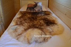 a bed with an animal print on it and a book sitting on top of it