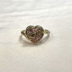 "Set in 10K yellow gold, this Pink Ice CZ says \"I love you\"... literally! The heart shaped stone is 10.7x9.5mm and equals over 3 carats! Size 6 Total weight is 2.13g We can resize rings for a fee. Please inquire!" Vintage Heart Cut Ring As A Gift, Vintage Heart Cut Heart Ring As Gift, Vintage Heart Cut Ring As Gift, Vintage Heart Ring With Birthstone For Valentine's Day, Valentine's Day Hallmarked Heart Ring, Vintage Heart Cut Birthstone Heart Ring, Heart Cut 14k Gold Heart Ring For Valentine's Day, 14k Heart Cut Ring For Valentine's Day, Vintage Heart Cut Ring For Anniversary