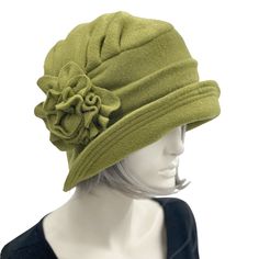 "HANDMADE IN THE USA with care and attention to detail. With over 30 years of experience and our own unique hand-cut patterns! Designs with a vintage vibe and a modern-day twist! The beautiful Alice this time shown here hand made in a soft, dusky olive green fleece. A mid width brim which is wider in front than the back. There are many other color options. Please choose your favorite from the drop-down box. Fleece is a great choice for a winter hat because it is so warm and comfortable. It also Cappello Cloche, Bespoke Hats, Downton Abbey Fashion, Fleece Hats, Hat Stand, Fleece Hat, Chemo Hat, Flapper Style, Fancy Hats