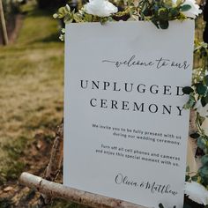 a sign that says welcome to us and unplugged ceremony with flowers on it