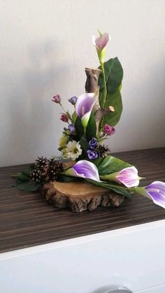 a vase filled with flowers sitting on top of a wooden table