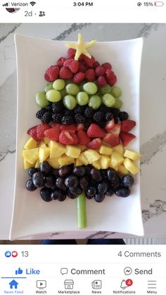 a christmas tree made out of fruit on a white plate with an instagramr