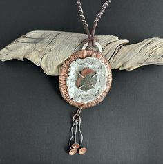 Discover the beauty of nature with this handmade necklace, crafted from textured copper and sterling silver. At its heart lies a unique Lake Superior beach stone set with prongs to showcase its natural beauty. The necklace features an adjustable leather cord, allowing you to wear it at a length that suits your style, from 24 to 30 inches. Adding to its charm are three delicate sterling silver and copper dangles. Perfect for those who appreciate nature-inspired jewelry, this piece brings a touch of rustic elegance to any outfit. Pendant Width 2-3/4" Pendant Height 6" (includes dangles) Rustic Copper Pendant Jewelry, Silver Hammered Copper Necklace, Rustic Silver Handmade Necklaces, Rustic Handmade Silver Necklaces, Artisan Rust-colored Jewelry For Gifts, Hammered Brown Jewelry For Gift, Rustic Handmade Silver Necklace, Artisan Hand Forged Rust Jewelry, Brown Hammered Jewelry As A Gift