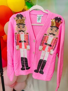 •The most fun cardigan of the season! The nutcrackers are adorable and you will turn heads while wearing this one! •Wear it as a top by itself or throw a Christmas graphic tee under! Pink Nutcracker, Queen Of Sparkles, Sparkle Skirt, Sequin Sleeve, Simple Top, Fall Capsule Wardrobe, Denim Romper, Pink Sequin, Party Looks