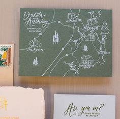 the wedding stationery is laid out on top of each other, including envelopes and stamps