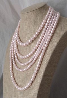 "PREFERENTIAL POLICIES : The order is $20 or more.There will be a 10% discount. Please use the coupon code: CZH10 Welcome back to my shop: https://www.etsy.com/shop/pearlandjewelry Description of the product in the picture: The necklace is 16---26 inches long ,I make the necklace to use 6mm 8mm 10mm light pink glass pearls,5 strands glass pearl necklace ,It is nice for your wedding. This necklace included: one layer (16\") 6mm 8mm 10mm ivory glass pearls. one layer (19\") 8mm ivory glass pearls. Elegant Pink Pearl Beaded Necklace, Pink Pearl Chain Jewelry For Wedding, Pink Pearl Bridal Necklace Gift, Pink Pearl Bridal Necklace As A Gift, Pink Round Bead Pearl Necklace For Wedding, Pink Pearl Chain Beaded Necklaces For Wedding, Pink Pearl Necklaces For Wedding, Pink Round Beads Pearl Necklace For Wedding, Pink Pearl Chain Beaded Necklace For Wedding