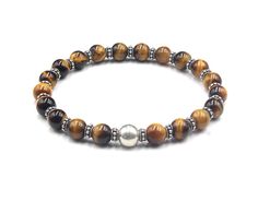 This bracelet features 8mm Grade A Tiger's Eye stone beads accented with a single 10mm sterling silver ball bead and 6mm sterling silver rondelle beads. We use silicon stretch cord for superior strength and resilience. Your bracelet comes in a bracelet gift box. Select your wrist measurement from the drop down menu. We will make your bracelet to fit. Brown Bracelets With Silver Round Beads, Bracelet Man, Bracelet Gift Box, Howlite Bracelet, Lapis Lazuli Bracelet, Designer Bracelet, Bracelets Design, Mens Gold Bracelets, Tiger Eye Bracelet