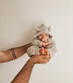 a man holding a baby doll in his hands