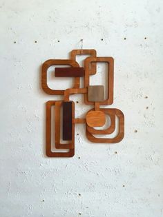 an abstract wooden sculpture on a white wall