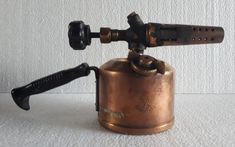 an old fashioned propaner with two wrenches on it