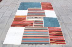 a multicolored rug is laying on the ground