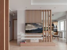 a living room filled with furniture and a flat screen tv on top of a wooden wall