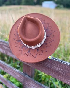 Stay stylish and sun-safe with the In Full Bloom Rancher Hat. Crafted with a full brim design, this chic hat features a beautiful hand burned sunflower, perfect for those who favor boho looks. Bohemian Brown Fedora With Curved Brim, Bohemian Sun Hat One Size Fits Most, Bohemian Sun Straw Hat, Brown Brimmed Hippie Hat, Brown Wide Brim Hippie Hat, Brown Hippie Brimmed Hat, Bohemian Sun Hat, Hippie Brown Hat With Curved Brim, Brown Bohemian Sun Hat For Festivals