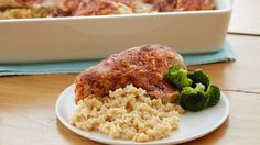 a white plate topped with meat and rice next to a casserole dish filled with broccoli